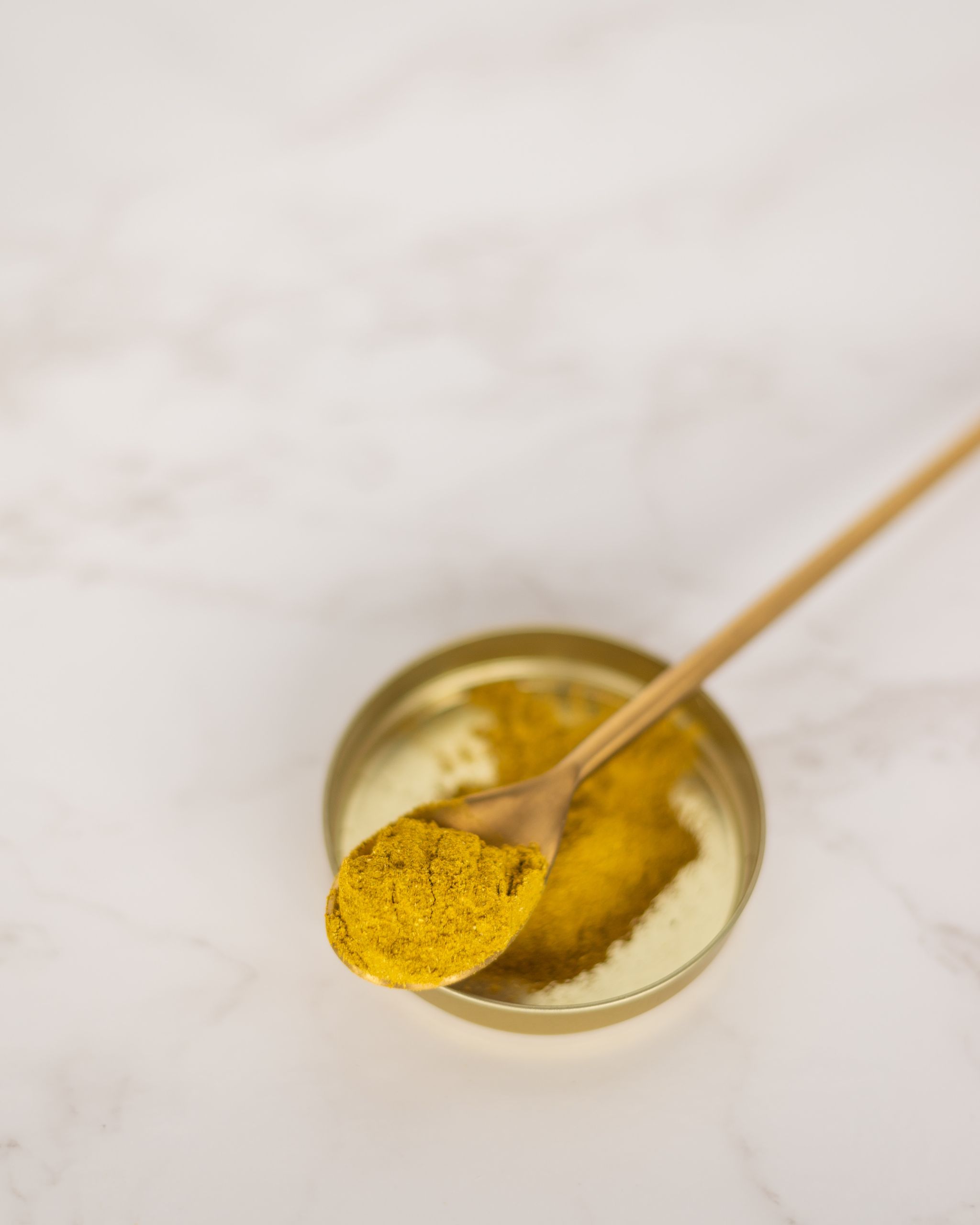 Curcuma powder on a spoon.